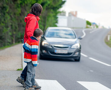 18256202 - mother and son passing a street when a car coming